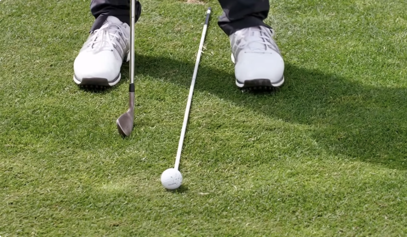 Alignment Stick Ball Position Alignment stick showing ball position in pro golfers stance